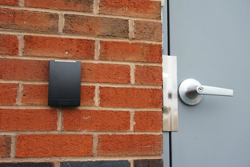 Secure It Controls technician performing access control readers installation in an older commercial building in Fort Collins and Loveland Colorado