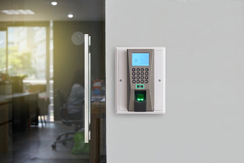 Biometric access control fingerprint reader installed in a modern office setting