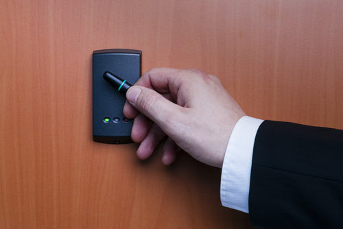 Technician using smartphone credential on Paxton10 reader during access control installation by Secure It Controls