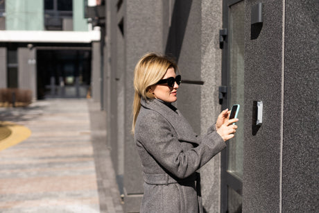 Person unlocking a door using VIZpin Entegrity Bluetooth smartphone access control system