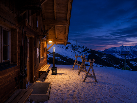 Empty snow-covered mountain cabin protected by a temporary vacation home security system in Colorado.
