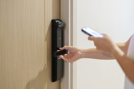 Resident using wireless apartment access control to unlock a unit door with a smartphone
